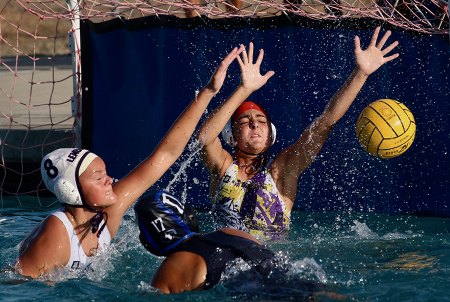 Lemoore's Emma DeBurger helps out Alisa Cuthbertson in girls' water polo action Tuesday at Hanford West High School.